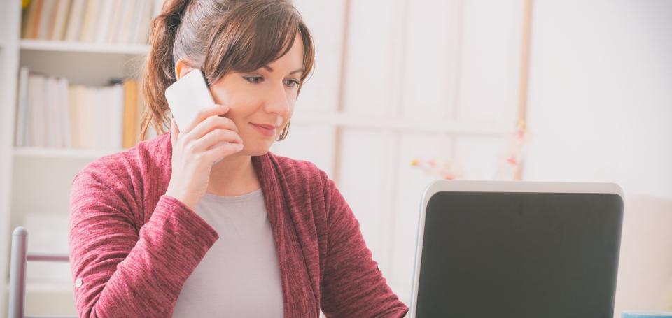 Woman at Computer on Phone