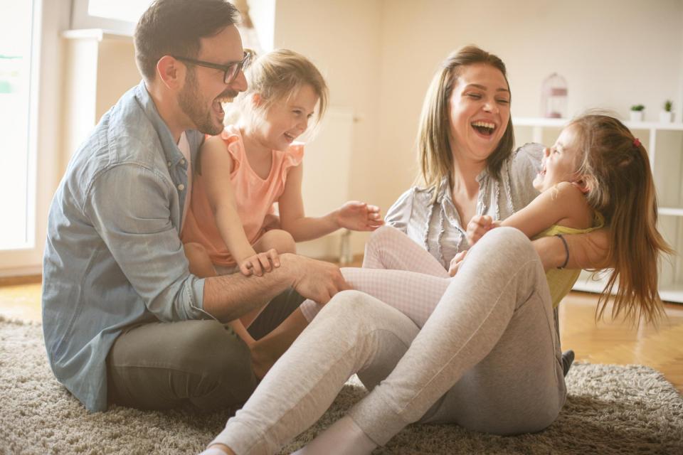 Happy Family on Floor of Living Room